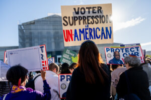 Demonstrators protest in favor of the Voting Rights Act outside the Supreme Court on Oct. 15, 2025.
