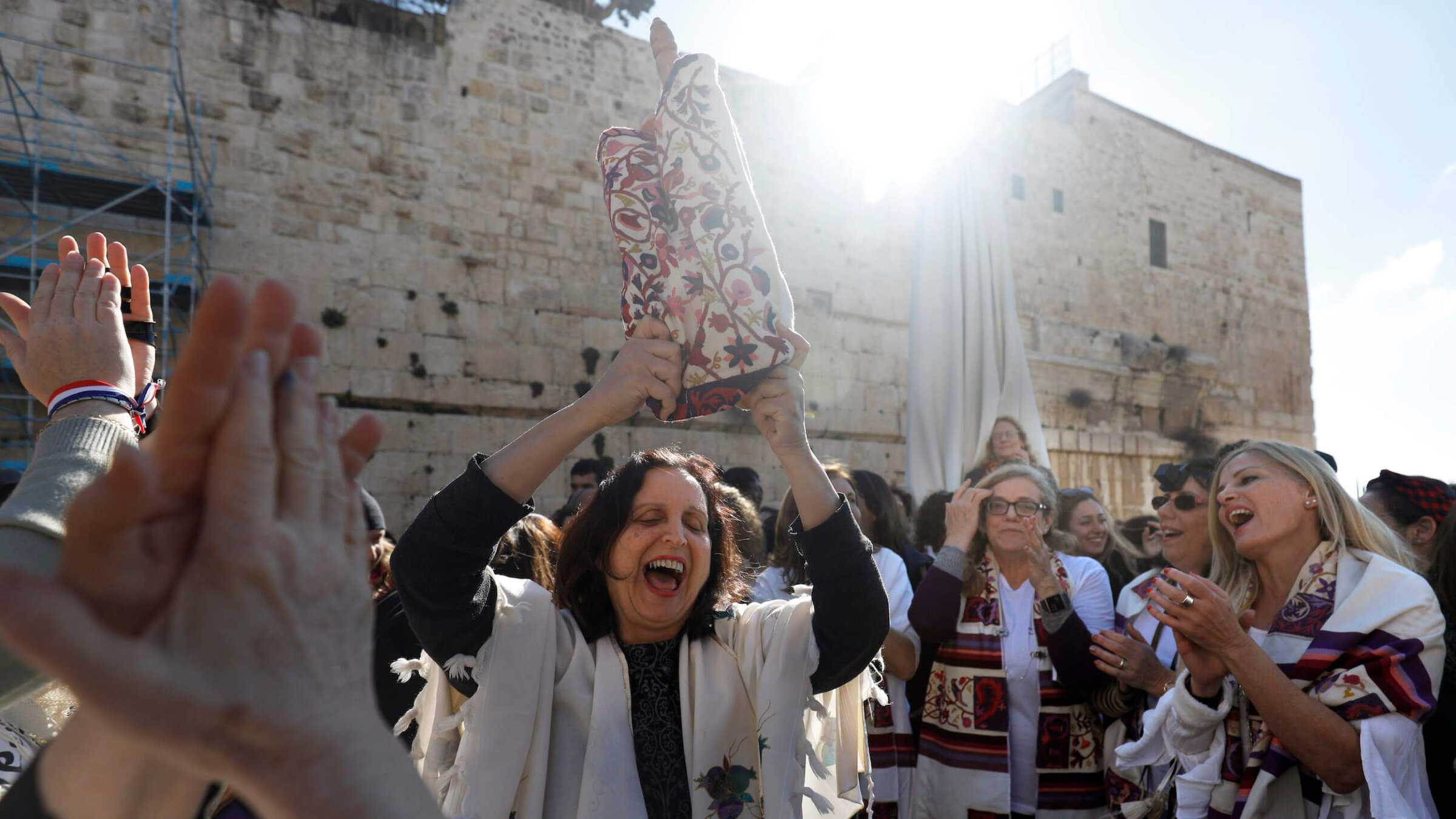 A member of the liberal Jewish religious movement "Women of the Wall" dances with a Torah scroll during an event marking the organization's 30th anniversary on March 8, 2019.