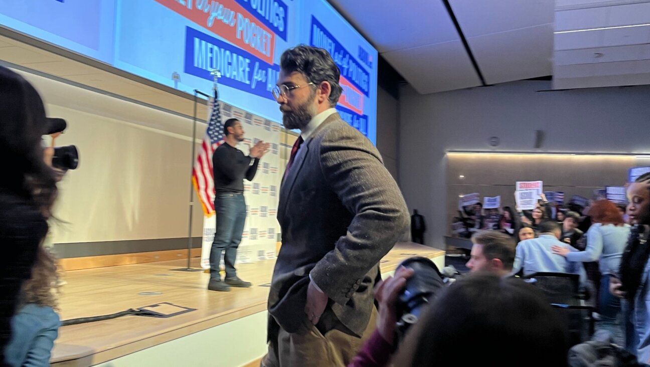 Hasan Piker looks on as U.S. Senate candidate Abdul El-Sayed delivers a stump speech in Ann Arbor, Michigan, April 7, 2026. Piker, a popular Twitch streamer accused of antisemitism, prompted controversy for campaigning with El-Sayed. (Andrew Lapin/JTA)