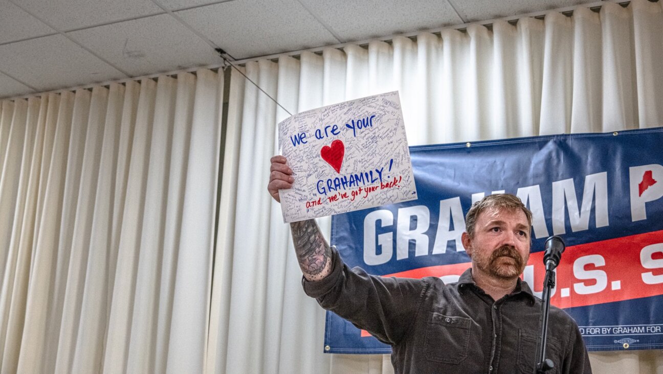 Democratic U.S. Senate candidate Graham Platner holds up a handwritten card signed by supporters present at a town hall at the Elks Lodge 188 on June 7, 2026 in Portland, Maine. Platner is the presumptive Democratic nominee and will face incumbent Sen. Collins (R-ME) for Maine’s U.S. Senate seat in the general election. (Laura Brett/Getty Images)