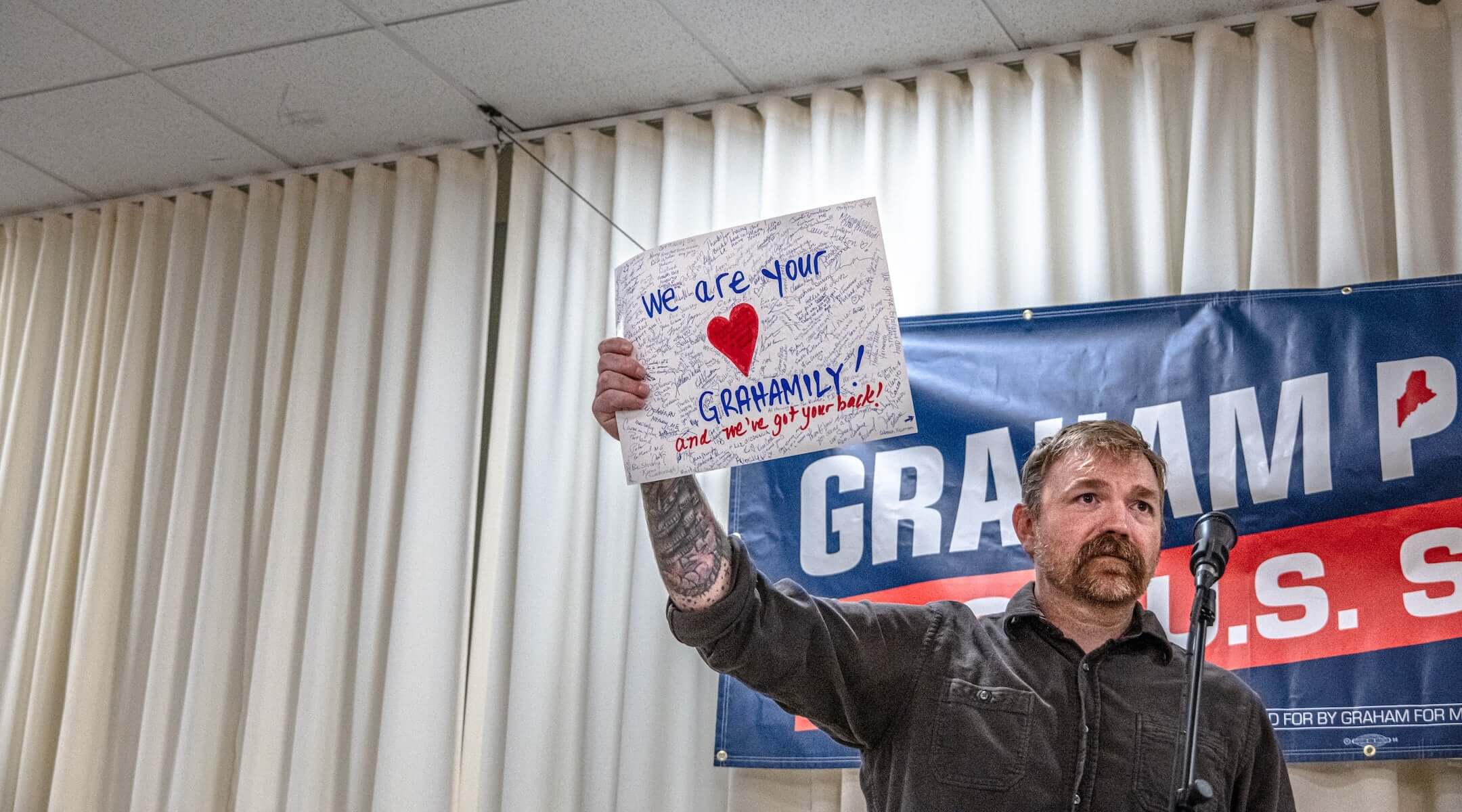 Democratic U.S. Senate candidate Graham Platner holds up a handwritten card signed by supporters present at a town hall at the Elks Lodge 188 on June 7, 2026 in Portland, Maine. Platner is the presumptive Democratic nominee and will face incumbent Sen. Collins (R-ME) for Maine’s U.S. Senate seat in the general election. (Laura Brett/Getty Images)