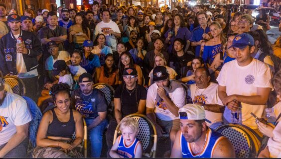A diverse crowd of Knicks fans watch at one of the massive watch parties amassing on New York City's streets.