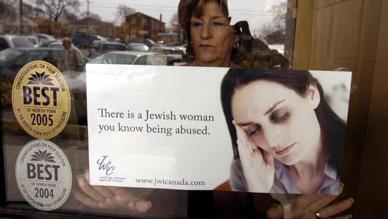A poster promoting a 2005 domestic violence awareness campaign by the Canadian branch of Jewish Women International is displayed in a Toronto window.