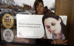 A poster promoting a 2005 domestic violence awareness campaign by the Canadian branch of Jewish Women International is displayed in a Toronto window.