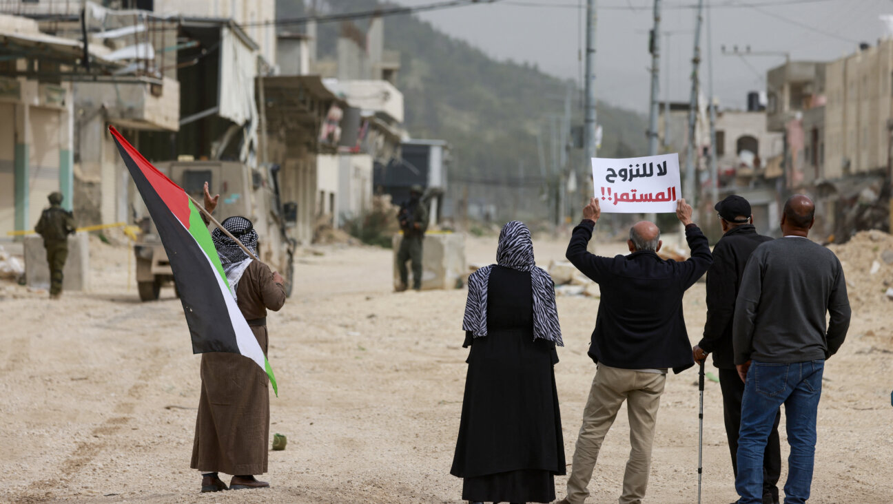 Palestinians protest after Israeli soldiers blocked the entrance of the Nur Shams Palestinian refugee camp in the occupied West Bank on February 9, 2026, demanding to be allowed to return to their homes from which they were expelled during an Israeli army operation. 