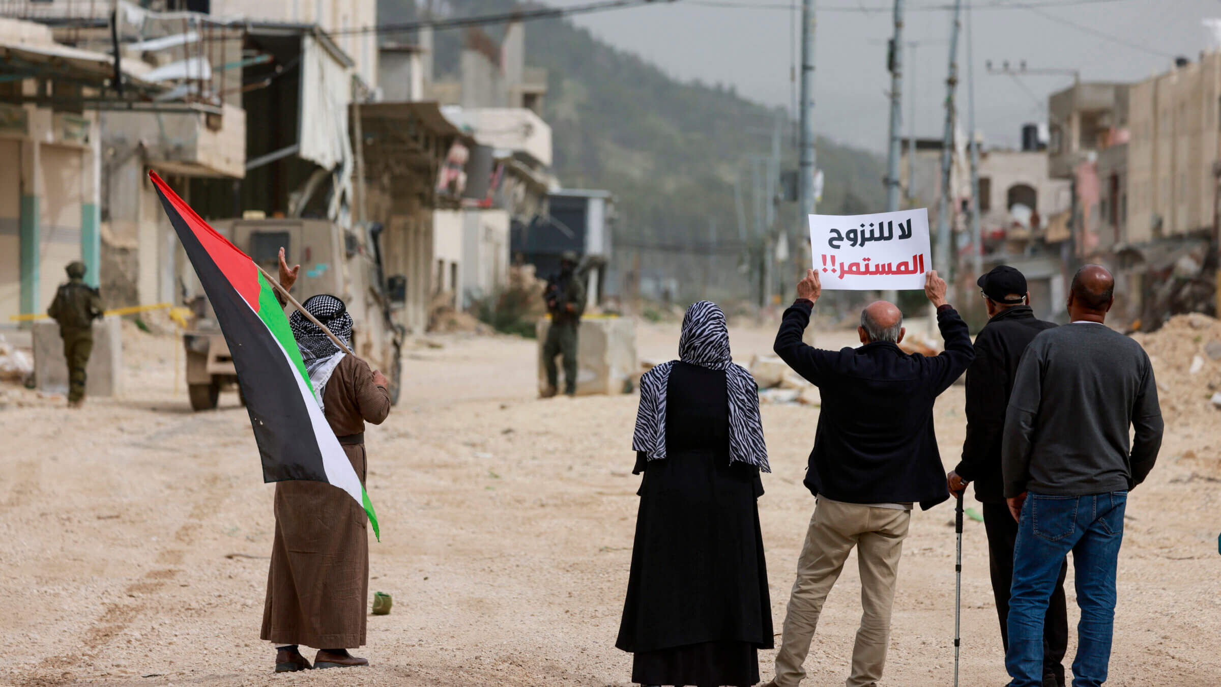 Palestinians protest after Israeli soldiers blocked the entrance of the Nur Shams Palestinian refugee camp in the occupied West Bank on February 9, 2026, demanding to be allowed to return to their homes from which they were expelled during an Israeli army operation.
