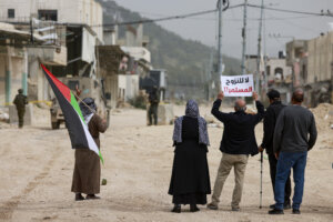 Palestinians protest after Israeli soldiers blocked the entrance of the Nur Shams Palestinian refugee camp in the occupied West Bank on February 9, 2026, demanding to be allowed to return to their homes from which they were expelled during an Israeli army operation. 
