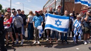 Pro-Israel counter-protesters face the main protest against the Great Israeli Real Estate Event at Edgware United Synagogue on June 14, 2026 in London. (Denise Baker/Getty Images)