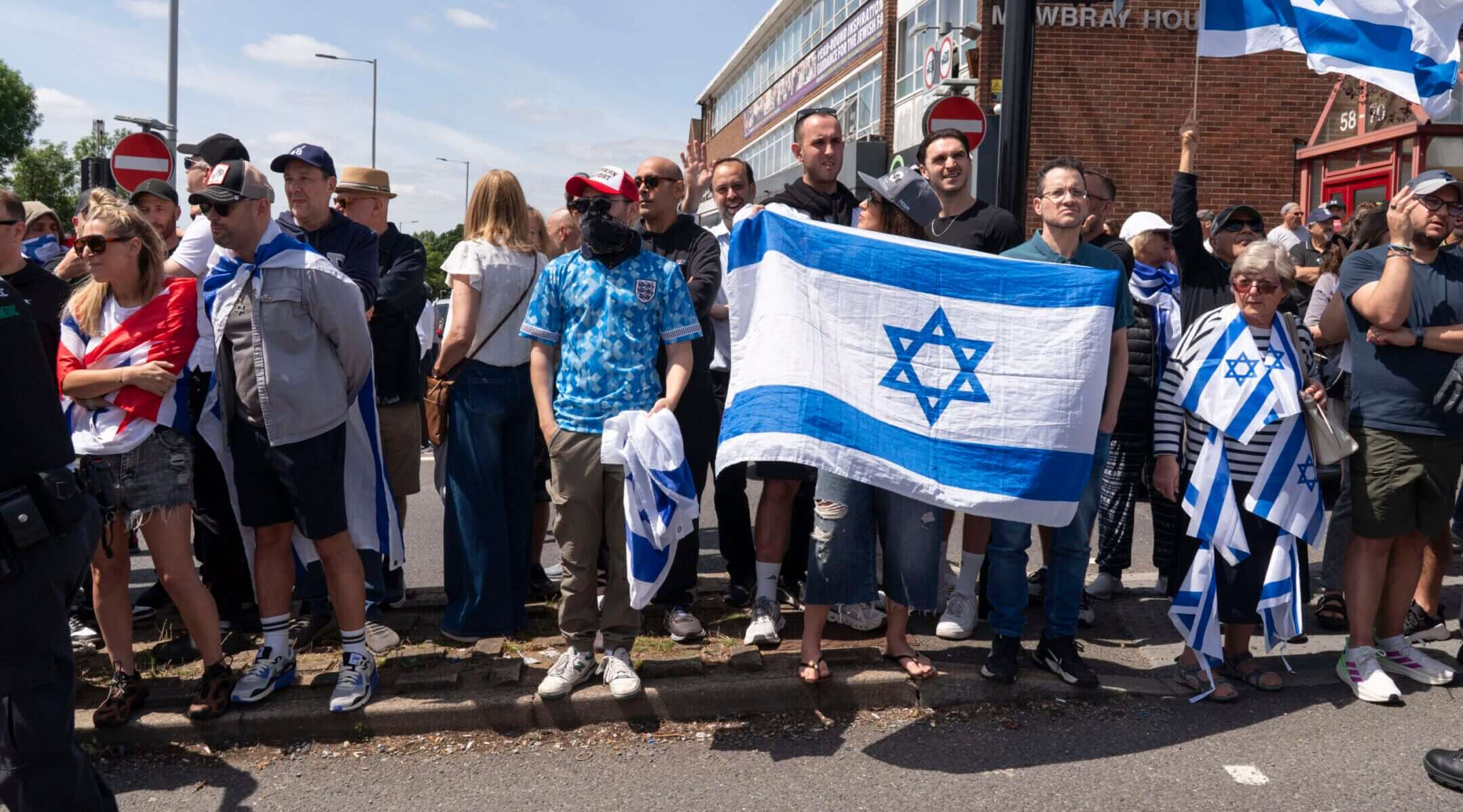 Pro-Israel counter-protesters face the main protest against the Great Israeli Real Estate Event at Edgware United Synagogue on June 14, 2026 in London. (Denise Baker/Getty Images)