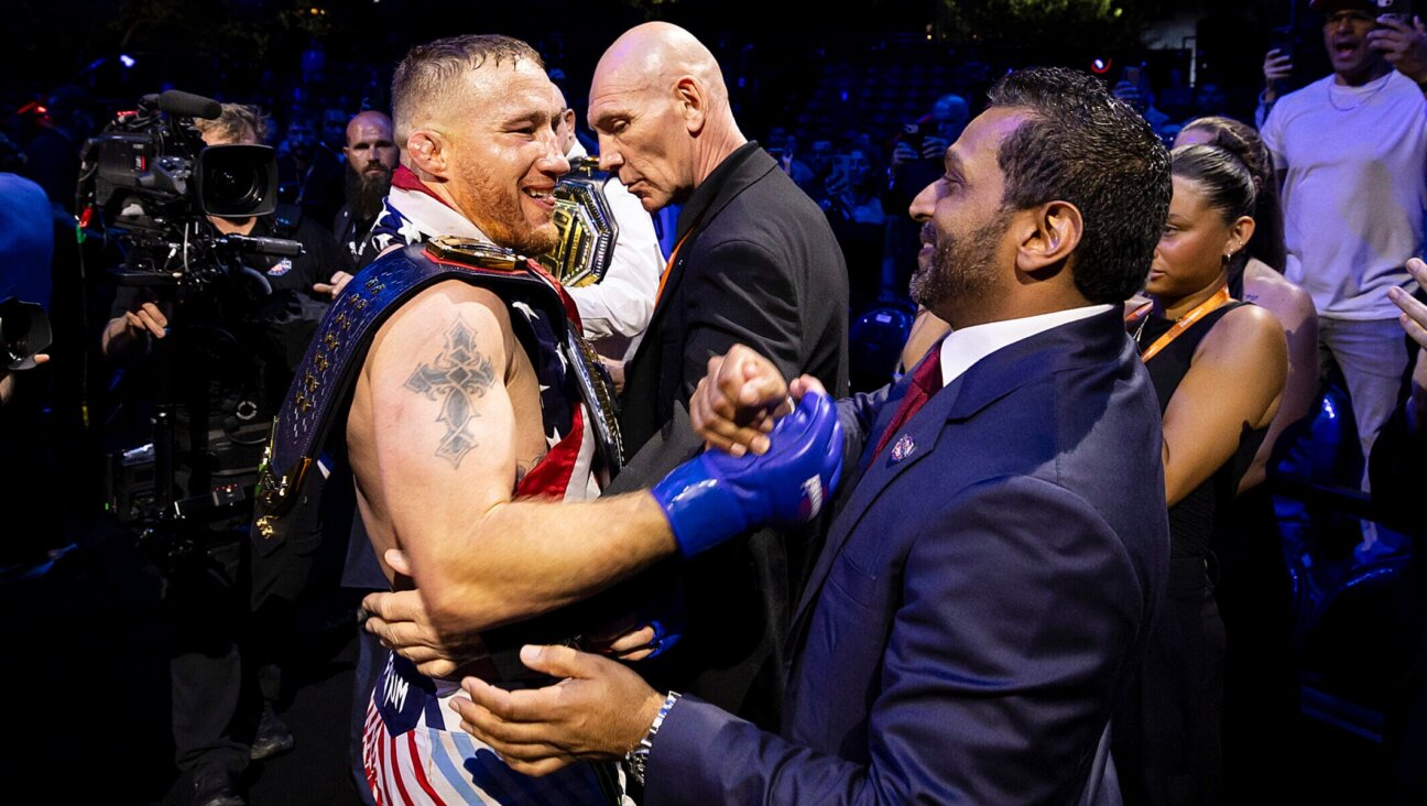 Justin Gaethje and FBI Director Kash Patel shake hands during the UFC Freedom 250 event on the South Lawn of the White House on June 14, 2026 in Washington, D.C. (Michelle Farsi/Zuffa LLC)