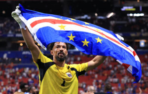 Vozinha, the Cape Verde goalkeeper, waves the national flag after the 0-0 draw with Spain.