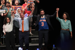 Congressional candidate Claire Valdez, Congressional candidate Brad Lander, Mayor Zohran Mamdani, and Congressional candidate Darializa Avila Chevalier raise their hands during a rally at King's Theater in New York City. 