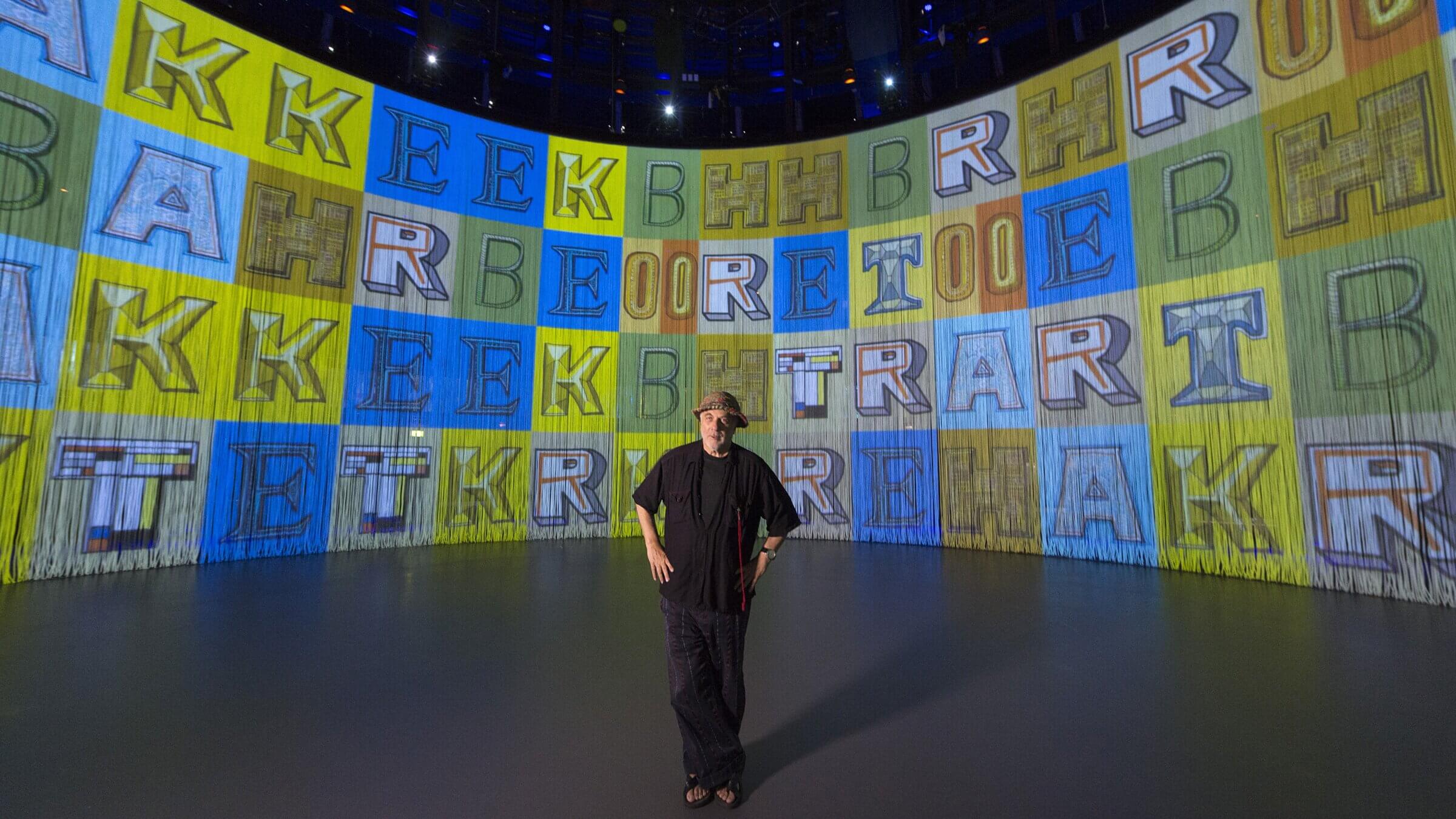 Rod Arad stands near the screen into the art installation 'Curtain Call.' London, 2016.