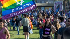 Attendees wave flags at the Jerusalem March for Pride and Tolerance, June 4, 2026. (Theia Chatelle)