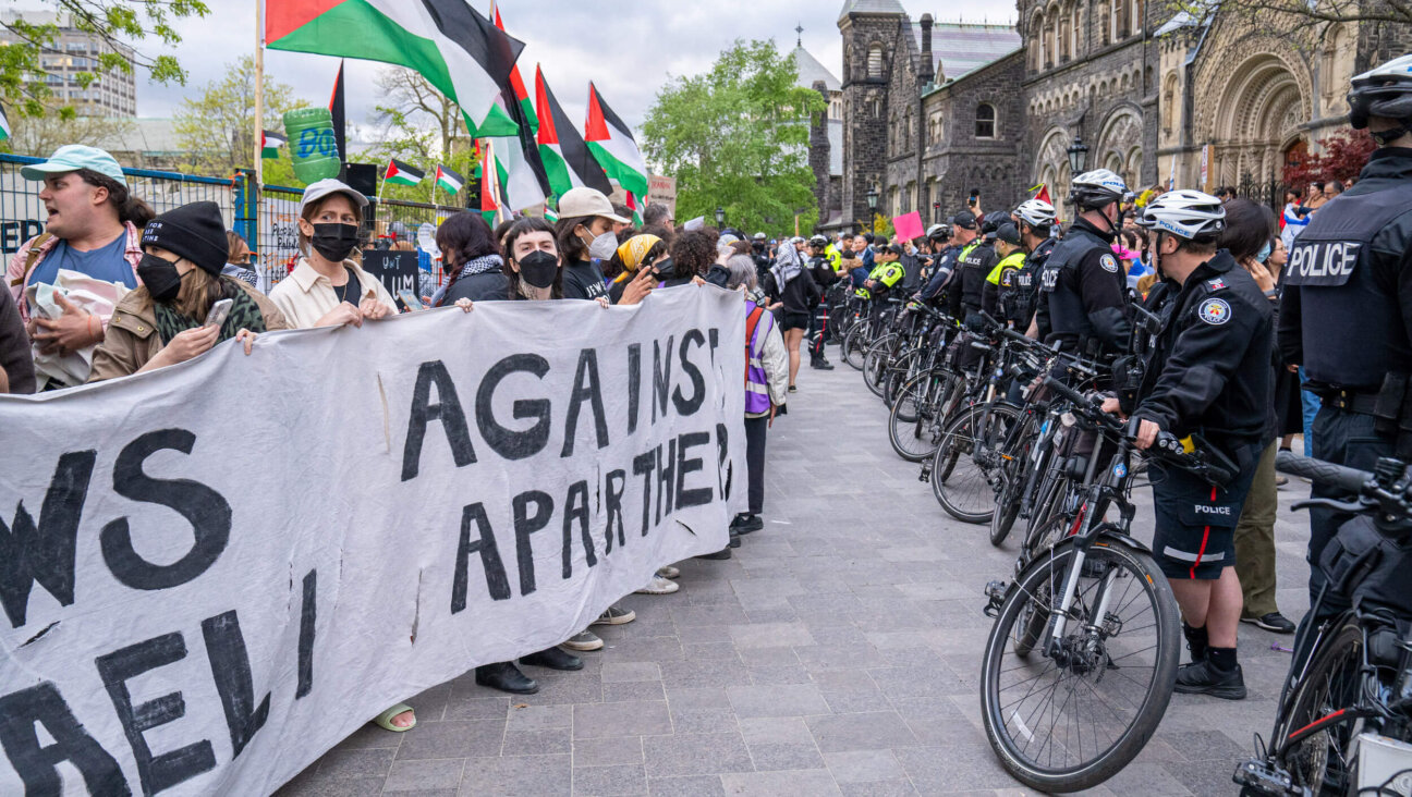 Jewish students supporting Palestinians hold a banner that says "Jews against Israeli Apartheid" during a 2024 rally at the University of Toronto.