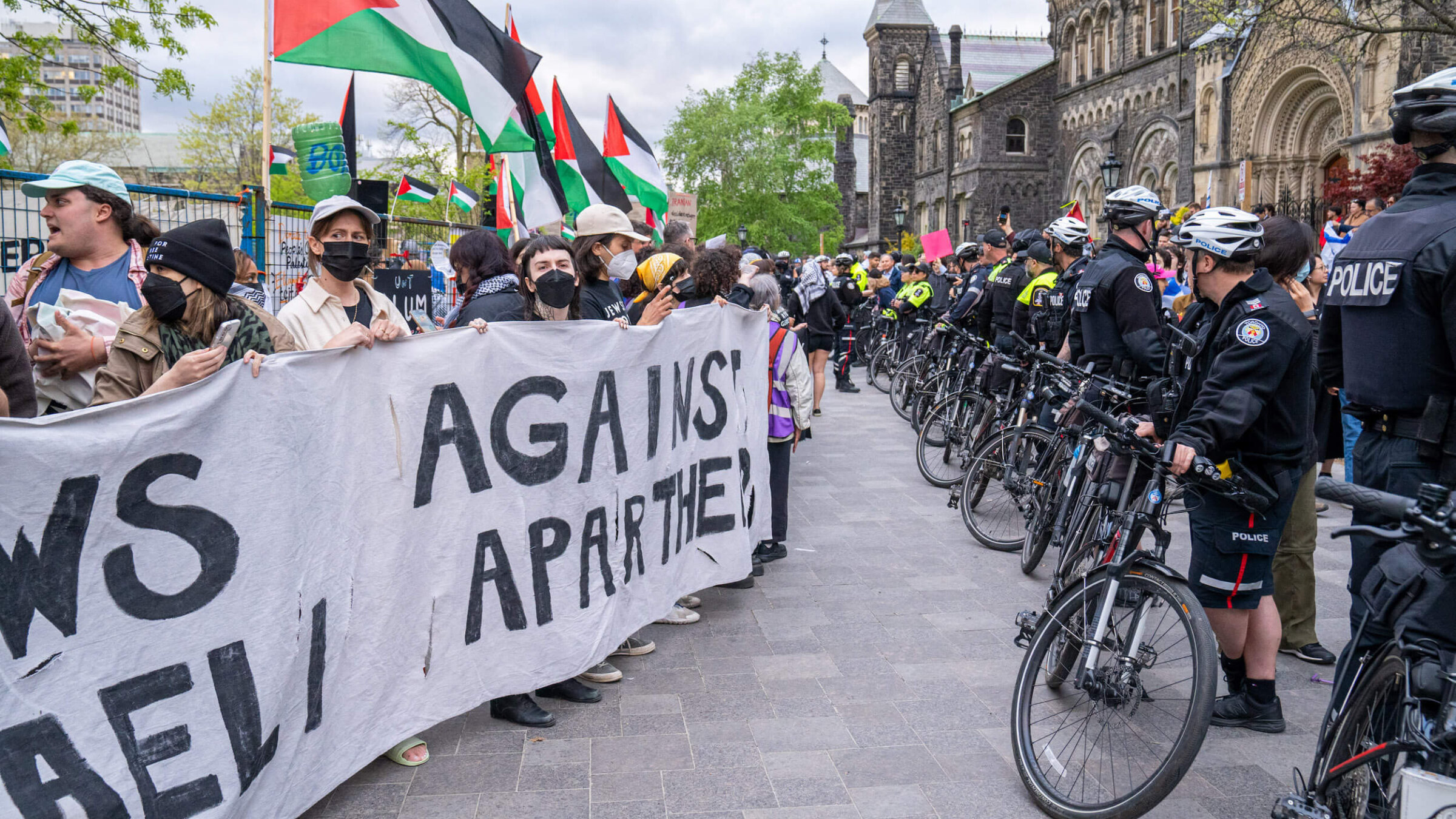 Jewish students supporting Palestinians hold a banner that says "Jews against Israeli Apartheid" during a 2024 rally at the University of Toronto.