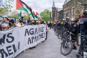 Jewish students supporting Palestinians hold a banner that says "Jews against Israeli Apartheid" during a 2024 rally at the University of Toronto.