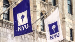 Two NYU flags flying above entrance to Frederick Loewe Theatre on New York University campus. (Plexi Images/GHI/UCG/Universal Images Group via Getty Images)