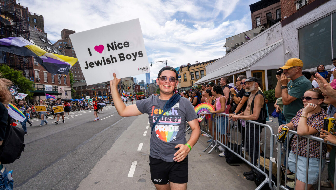 A man carrying a sign from the Jewish LGBTQ+ organization Keshet takes part in the 2025 NYC Pride March on June 29, 2025.