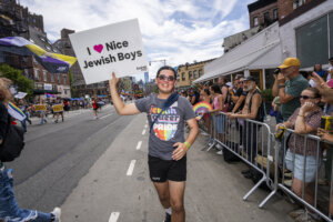 A man carrying a sign from the Jewish LGBTQ+ organization Keshet takes part in the 2025 NYC Pride March on June 29, 2025.